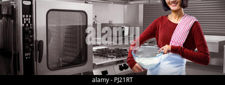 Composite image of smiling female chef mixing flour in bowl with whisk Stock Photo