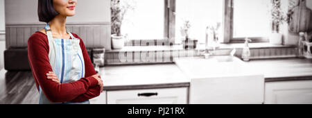 Composite image of waitress standing with arms crossed against white background Stock Photo