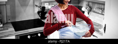 Composite image of female chef mixing flour in bowl with whisk Stock Photo