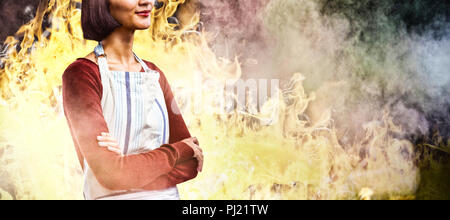 Composite image of waitress standing with arms crossed against white background Stock Photo