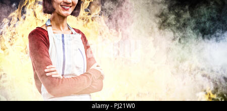 Composite image of smiling waitress standing with arms crossed against white background Stock Photo