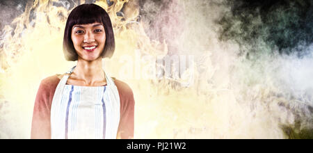 Composite image of smiling waitress in apron standing against white background Stock Photo