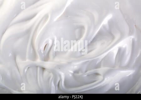 close up of a white whipped or sour cream on white background. Stock Photo