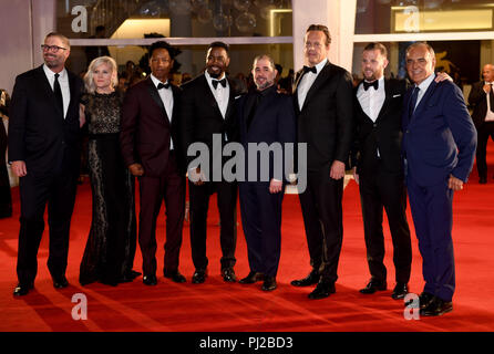 Venice, Italy. 3rd Sept 2018. The actors Tory Kittles (3rd from left), Michael Jai White (4th from left), the director S. Craig Zahler (5th from left), and the actor Vince Vaughn (6th from left), the actor Sefton Fincham and the festival director, Alberto Barbera (right) can be seen on the red carpet of the film screening 'Dragged Across Concrete' at the Venice Film Festival. The film festival runs from 29 August to 8 September and is taking place for the 75th time this year. Photo: Felix Hörhager/dpa Stock Photo