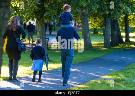 Aberystwyth Wales UK,Tuesday 04 September 2018  UK Weather: Parents with their children  walking to primary school through the park in Aberystwyth on the first day of the Autumn term, on a bright, sunny but crisp and cold morning  photo © Keith Morris Credit: keith morris/Alamy Live News Stock Photo