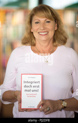 Dresden, Germany. 04th Sep, 2018. 04.09.2018, Saxony, Dresden: Petra Köpping (SPD), Minister of Integration of Saxony, holds her book 'Integriert doch erst uns!' (Integrate us first!). at a press conference. Credit: Monika Skolimowska/dpa-Zentralbild/dpa/Alamy Live News Stock Photo