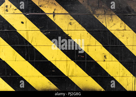 Black and yellow lines on wall. Danger sign Stock Photo