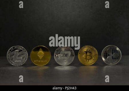 a litecoin and ethereum and dash and bitcoin and ripple together for a black background ,Coins of the four crypto currencies with the highest market capitalization  Stock Photo