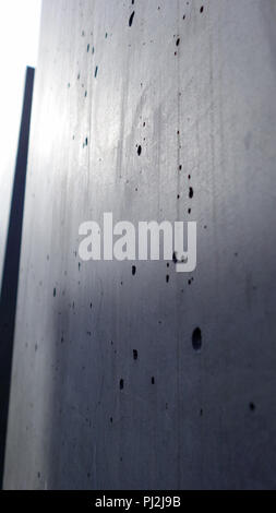 Smooth polished concrete with hairline cracks and small bubble holes Stock Photo