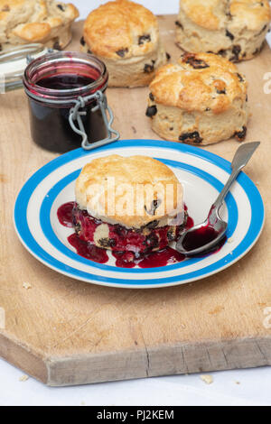 Homemade fruit scones with runny blackcurrant jelly. UK Stock Photo