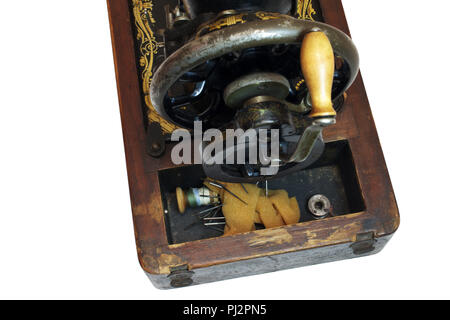 Compartment of vintage sewing machine for storing thread, spools, needles and small spare parts. is open. isolated on white , with clipping path Stock Photo