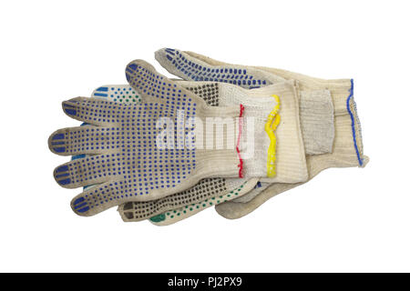 stack of knitted working gloves with colorful rubber dots, neatly arranged on the white background. elastic cuffs, bordered by blue, red and yellow Stock Photo