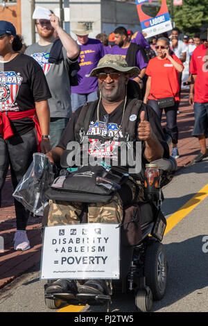 Detroit, Michigan - 3 September 2018 - A disabled man in a wheelchair joins Detroit's Labor Day parade. Stock Photo
