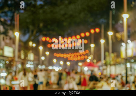 Jalan Alor in nighttime- Food Street in Kuala Lumpur City Center. Blurred photo of city night street, people walking, illumination, advertising board  Stock Photo