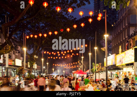 Jalan Alor in nighttime- Food Street in Kuala Lumpur Center. Blurred photo of city night street, people walking, illumination, advertising boards Stock Photo