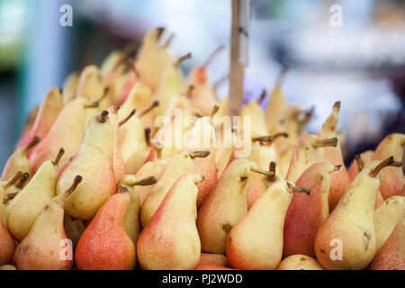 European pears, yellow and red, for sale on a market in Belgrade, Serbia. Also known as Pyrus Communis, or common pear, it is a traditionnal fruit for Stock Photo