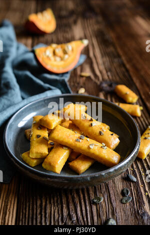 Salty Hokkaido pumpkin crackers topped with seeds Stock Photo