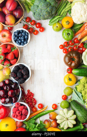 Healthy summer fruits vegetables berries arranged in a frame, cherries peaches strawberries cabbage broccoli cauliflower squash tomatoes carrots beetroot, copy space, top view, selective focus Stock Photo