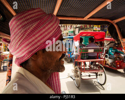 Tuk Tuk driver waiting for customers at Main Bazar Paharganj, Sangatrashan, New Delhi, India Stock Photo