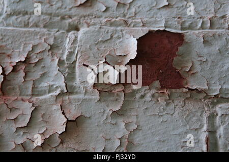 old paint peeling from brick wall Stock Photo