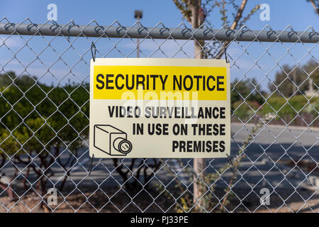 Security Notice – Video Surveillance in Use on These Premises, sign on fence; California, USA Stock Photo