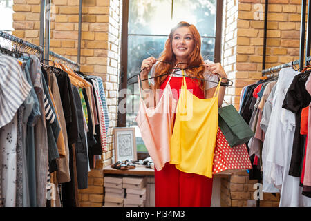 Excited girl having wonderful day and buying new clothes Stock Photo Alamy