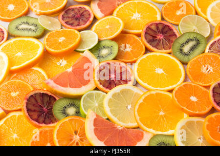 Colourful fruits background oranges, clementines, blood oranges, kiwis and grapefruits on white table, selective focus Stock Photo