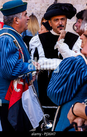 Local People Dressed In Medieval Costume Wait for The Assignment Of The Horses Ceremony To Begin In The Piazza Del Campo, Palio di Siena, Siena, Italy Stock Photo