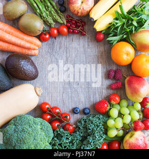 Different fruits and vegetables arranged in a circle, on the grey wooden table, top view, copy space for text, selective focus Stock Photo
