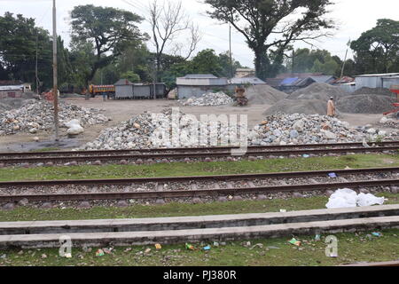 big granite stones boulders of various forms and sizes set.white stone floor in the garden.white stone wall background. Stock Photo