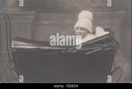 Vintage 1923 Photograph of a 15 Month Old Boy Called Billie Sitting Proudly In His Beautiful Pram Stock Photo