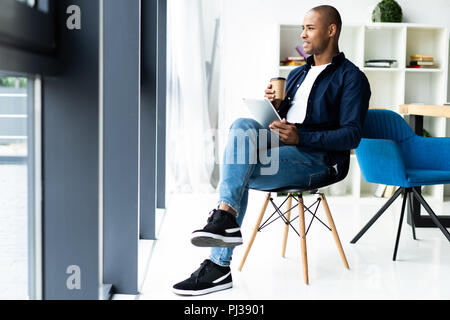 happy african american entrepreneur using tablet computer. Stock Photo