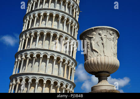 The Leaning Tower of Pisa, a wonderful medieval monument, one of the most famous landmark in Italy, with a replica of 14th century roman style vase Stock Photo