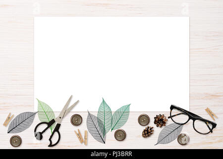 Craft elements and tools with white card on white painted wooden background. Flat lay. Top view. Stock Photo