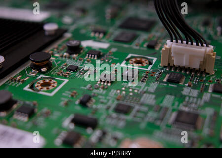 Lcd tv electronic circuit. Green color, faded at the sides. Stock Photo