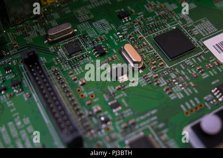 Lcd tv electronic circuit. Green color, faded at the sides. Stock Photo