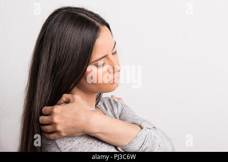 Portrait of a young beautiful woman with closed eyes in studio. Stock Photo