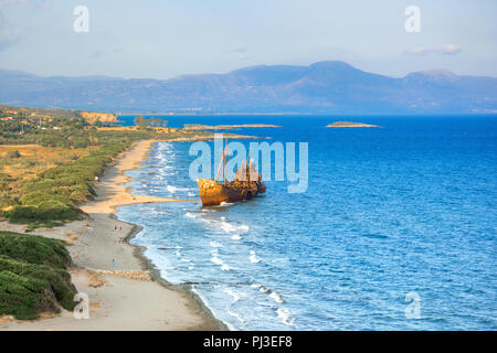 Greek coastline with the famous rusty shipwreck in Glyfada beach near Gytheio, Gythio Laconia Peloponnese Greece. Stock Photo