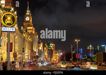 Night shot of the bund in Shanghai, China with busy traffic and taxi sign. Stock Photo