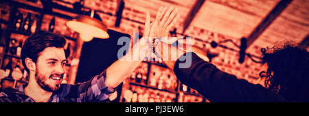 Two young men giving high five to each other Stock Photo