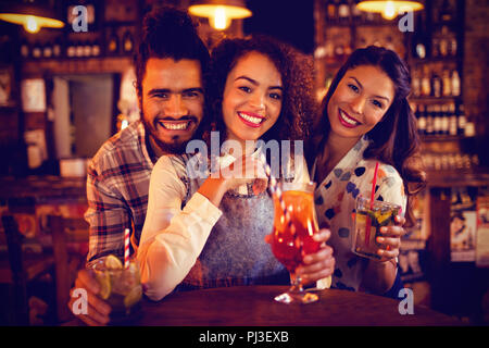 Portrait of young friends having drinks Stock Photo