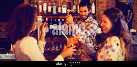 Bartender mixing a cocktail drink in cocktail shaker Stock Photo