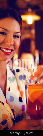 Portrait of young woman having cocktail drink Stock Photo