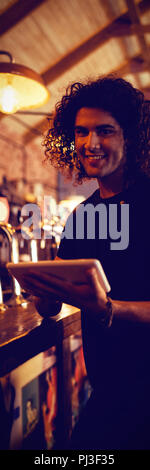 Portrait of young man using digital tablet Stock Photo