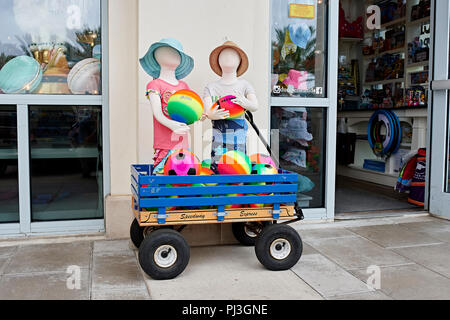 Retail store exterior display of colorful children's clothing and beach toys on front sidewalk in Seaside Florida, USA. Stock Photo