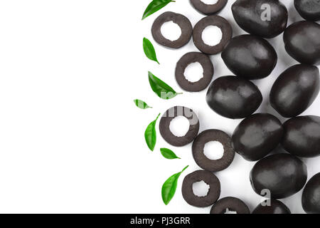 whole and sliced black olives decorated with leaves isolated on white background with copy space for your text. Top view Stock Photo