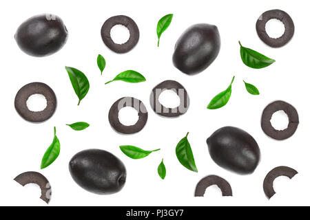 whole and sliced black olives decorated with leaves isolated on white background. Top view. Flat lay pattern Stock Photo