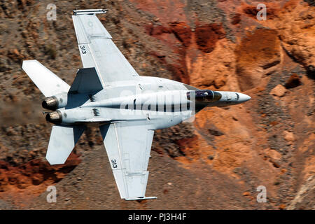 United States Navy Boeing F/A-18E Super Hornet (side 313) from the VFA-146 Blue Diamonds squadron flies low level on the Jedi Transition through Star Wars Canyon / Rainbow Canyon, Death Valley National Park, Panamint Springs, California, United States of America Stock Photo