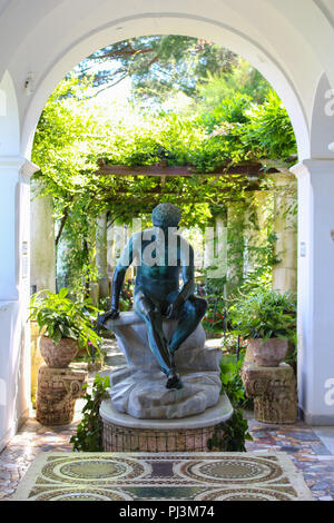 Capri, Italy - 2015-06-27 : A pergola with a Roman statue adorning Villa San Michele between the towns of Anacapri, and Capri, Italy Stock Photo