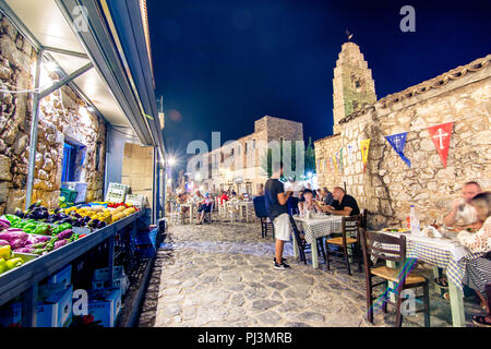 Night view of the traditional village of Areopoli in Mani region with the picturesque alleys and the stone built tower houses,  Peloponnese, Greece Stock Photo